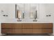 Modern bathroom features a double vanity, wood cabinets, and stylish fixtures at 28110 N 96Th Pl, Scottsdale, AZ 85262