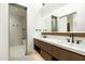 Modern bathroom with double vanity, large mirror, and walk-in shower at 28110 N 96Th Pl, Scottsdale, AZ 85262