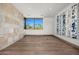 Spacious bedroom featuring hardwood floors, a large window with a scenic view, and modern art at 28110 N 96Th Pl, Scottsdale, AZ 85262