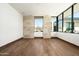 Bright bedroom with hardwood floors and stone feature wall at 28110 N 96Th Pl, Scottsdale, AZ 85262