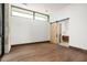 Spacious bedroom with wood floors and barn door to ensuite bathroom at 28110 N 96Th Pl, Scottsdale, AZ 85262