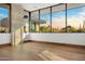 Bright bedroom with hardwood floors, large windows, and stunning views of the desert landscape at 28110 N 96Th Pl, Scottsdale, AZ 85262