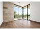 Bright bedroom with wood floors and large window overlooking desert landscape at 28110 N 96Th Pl, Scottsdale, AZ 85262