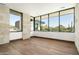 Bright bedroom with hardwood floors and stone feature wall at 28110 N 96Th Pl, Scottsdale, AZ 85262