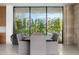 Dining room with large window, modern table, and comfortable gray chairs at 28110 N 96Th Pl, Scottsdale, AZ 85262