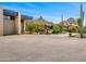 Wide driveway leading to an estate home framed by desert landscaping and a mountain view, creating a grand approach at 28110 N 96Th Pl, Scottsdale, AZ 85262