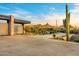 Modern home exterior featuring desert landscaping, a private driveway, and mountain views, capturing Arizona's beauty at 28110 N 96Th Pl, Scottsdale, AZ 85262