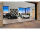 Spacious garage featuring luxury vehicles, large windows, and modern design elements at 28110 N 96Th Pl, Scottsdale, AZ 85262