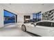 Modern garage with glass doors, showcasing two luxury cars at 28110 N 96Th Pl, Scottsdale, AZ 85262