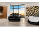 Luxury cars are parked in modern garage with large windows and artwork at 28110 N 96Th Pl, Scottsdale, AZ 85262