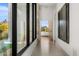 Hallway showcasing large windows with mountain views and tiled flooring with modern artwork at 28110 N 96Th Pl, Scottsdale, AZ 85262