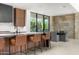 Modern kitchen with sleek countertops and stylish bar seating at 28110 N 96Th Pl, Scottsdale, AZ 85262