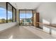 Sunlit living room with expansive windows offering desert views and a built-in desk at 28110 N 96Th Pl, Scottsdale, AZ 85262