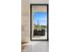 Framed view to the backyard, featuring desert landscaping and a swimming pool with mountain views beyond at 28110 N 96Th Pl, Scottsdale, AZ 85262