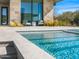 A modern pool with sparkling blue water, surrounded by a stone patio, seamlessly blending luxury and outdoor living at 28110 N 96Th Pl, Scottsdale, AZ 85262