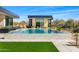 Stunning backyard with a modern pool, lush green lawn, and desert landscaping, perfect for outdoor entertaining at 28110 N 96Th Pl, Scottsdale, AZ 85262