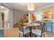 Bright dining area with a round table and four chairs near staircase and kitchen at 28731 N 20Th Ln, Phoenix, AZ 85085