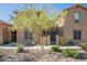 Tan stucco home with a landscaped front yard and walkway at 28731 N 20Th Ln, Phoenix, AZ 85085