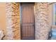 Inviting front door entrance with security screen door and stonework at 28731 N 20Th Ln, Phoenix, AZ 85085