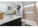 Well-lit bathroom featuring a shower with a bench and a dark vanity with sink at 29050 N Mountain View Rd, San Tan Valley, AZ 85143