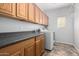 Functional laundry room with counter space, cabinets, and modern appliances at 29050 N Mountain View Rd, San Tan Valley, AZ 85143