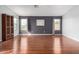 Bright main bedroom with hardwood floors, large windows, and neutral gray walls at 29050 N Mountain View Rd, San Tan Valley, AZ 85143