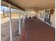 View of a home's covered deck with wood floor and supports as well as views of the desert landscape at 29967 N Sandridge Dr, Queen Creek, AZ 85144