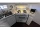 Clean kitchen with white cabinets, gas stove, and stainless sink on a speckled countertop at 29967 N Sandridge Dr, Queen Creek, AZ 85144