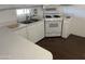 Well-lit kitchen featuring white countertops, cabinets, gas range, and stainless steel sink at 29967 N Sandridge Dr, Queen Creek, AZ 85144