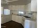 Bright kitchen with white cabinetry, countertops, and appliances at 29967 N Sandridge Dr, Queen Creek, AZ 85144