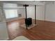 Cozy living room with wood-look flooring, a wood burning stove, and lots of natural light at 29967 N Sandridge Dr, Queen Creek, AZ 85144