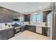 Modern kitchen with dark cabinetry, stainless steel appliances, and quartz countertops at 3344 S 82Nd St, Mesa, AZ 85212