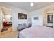 Main bedroom with a king bed, grey bench, and views into the living room at 34457 N Legend Trail Pkwy # 1018, Scottsdale, AZ 85262