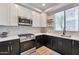 Modern kitchen with stainless steel appliances and white and dark wood cabinets at 34457 N Legend Trail Pkwy # 1018, Scottsdale, AZ 85262