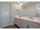 Bathroom with double vanity, white cabinets, and modern fixtures at 34690 N Ashwood Dr, San Tan Valley, AZ 85144