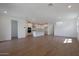 Bright and spacious living room with wood-look floors and open floor plan at 34690 N Ashwood Dr, San Tan Valley, AZ 85144