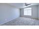 Sunlit bedroom with a large window and neutral carpeting, providing a calm space at 3591 S Larkspur Way, Chandler, AZ 85248