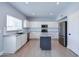 Modern kitchen featuring an island, white cabinets, stainless steel appliances, and tile backsplash at 3591 S Larkspur Way, Chandler, AZ 85248