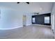 Spacious living room with vinyl floors, ceiling fan, and large windows at 3591 S Larkspur Way, Chandler, AZ 85248