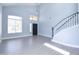 Bright living room featuring a staircase with a black handrail, vinyl floors, and many windows at 3591 S Larkspur Way, Chandler, AZ 85248