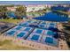 Aerial view of immaculate pickleball courts, conveniently located near a tranquil lake and modern condos at 3591 S Larkspur Way, Chandler, AZ 85248