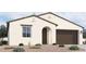 New single-story home with a two-car garage and attractive landscaping at 37749 N Cowboy Ln, San Tan Valley, AZ 85140