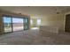 Spacious living room with sliding glass doors and access to backyard at 37749 N Cowboy Ln, San Tan Valley, AZ 85140