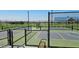 Two pickleball courts with fencing and a bench at 37749 N Cowboy Ln, San Tan Valley, AZ 85140