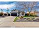 Charming two-story home with a dark garage door and desert landscaping on a sunny day at 4453 E Whitney Ln, Phoenix, AZ 85032