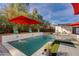 Relaxing pool area with water feature, potted plants, and seating at 4453 E Whitney Ln, Phoenix, AZ 85032