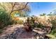 Backyard featuring a brick patio with chiminea, a bench, rock ground cover, and mature landscaping at 5373 W Dublin Ct, Chandler, AZ 85226