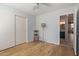 Bedroom features hard wood floors, closet, a small chair, and views to bathroom at 5373 W Dublin Ct, Chandler, AZ 85226