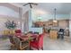 Open dining area with a vaulted ceiling, view of kitchen, and seating for six at 5373 W Dublin Ct, Chandler, AZ 85226