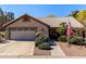 Charming single-story home featuring a tile roof, lush landscaping, and a two-car garage at 5373 W Dublin Ct, Chandler, AZ 85226